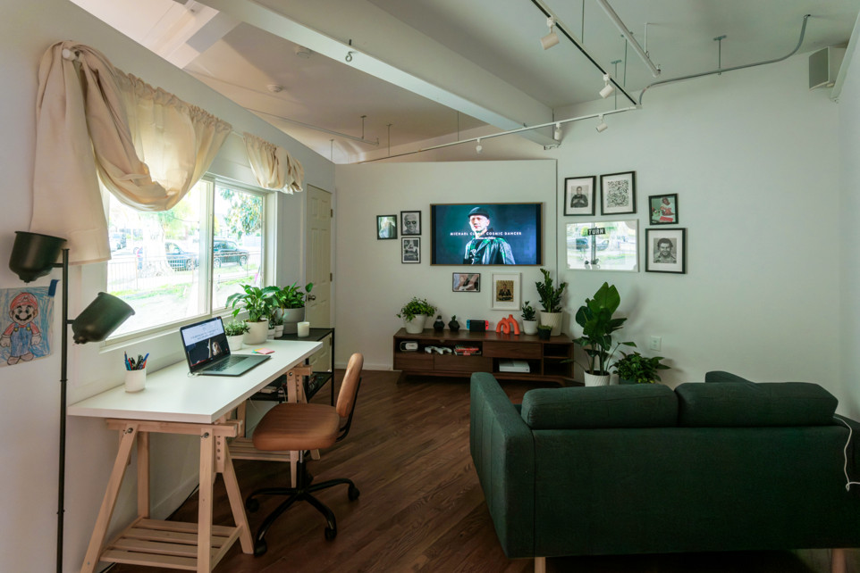 Room Two installation interior with seating and multiple TV screens